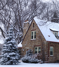 Photo of 123 Northern Way showing snow-covered exterior of country fieldstone nestled in forest